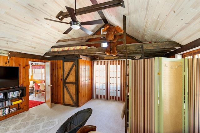 bedroom with vaulted ceiling, wooden ceiling, carpet flooring, wooden walls, and a barn door