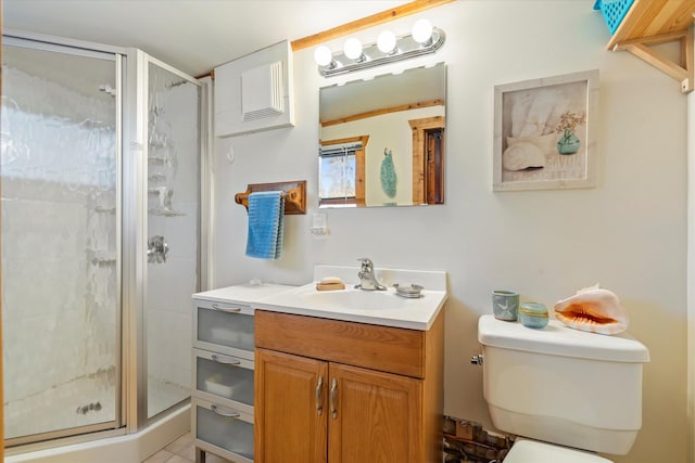 bathroom with a shower stall, toilet, and vanity