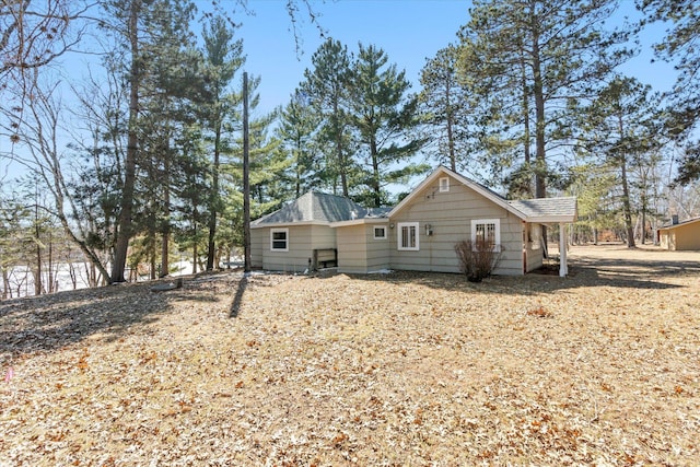 rear view of property with roof with shingles