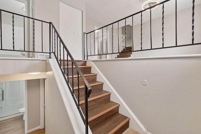 staircase with wood finished floors