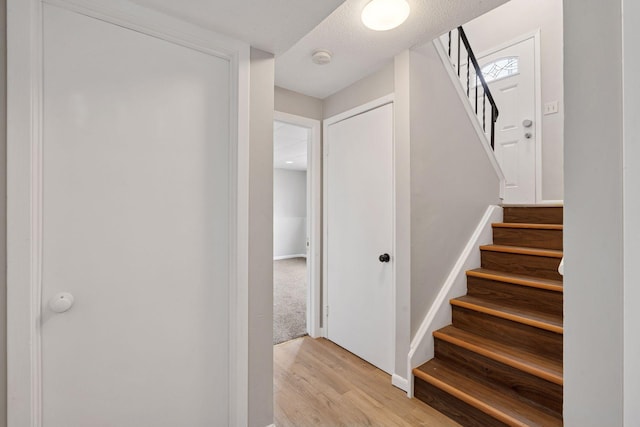 staircase with wood finished floors