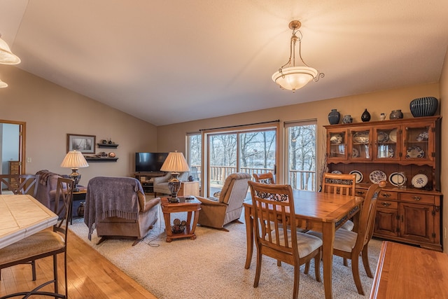 48987 Tamarac Dr, Scambler Twp, MN 56572 - dining space featuring vaulted ceiling and light wood-style flooring