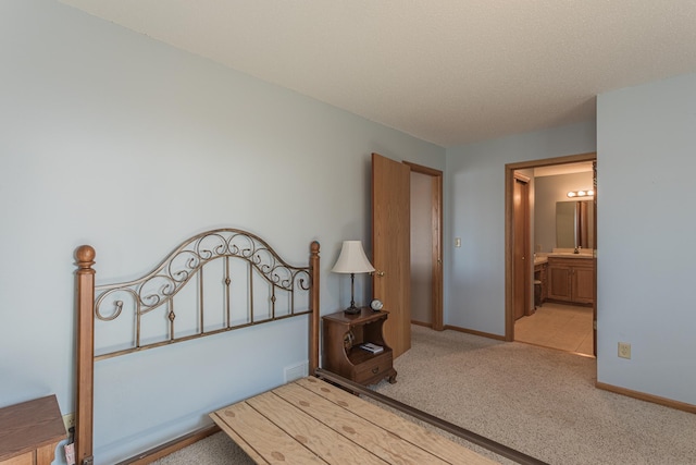 48987 Tamarac Dr, Scambler Twp, MN 56572 - carpeted bedroom with visible vents, baseboards, and connected bathroom