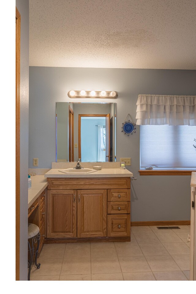 48987 Tamarac Dr, Scambler Twp, MN 56572 - bathroom featuring a textured ceiling, visible vents, tile patterned flooring, and vanity