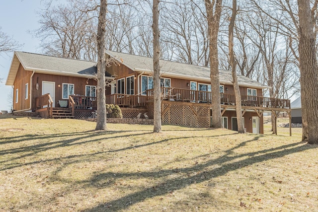 48987 Tamarac Dr, Scambler Twp, MN 56572 - back of property featuring a wooden deck, a shingled roof, and a yard