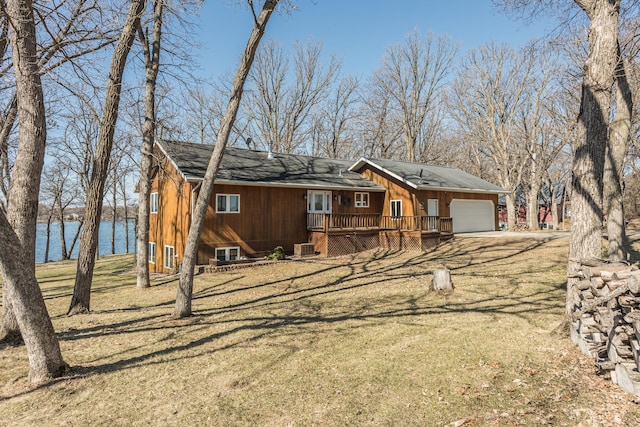 48987 Tamarac Dr, Scambler Twp, MN 56572 - view of front of home with a garage, a deck with water view, and a front lawn