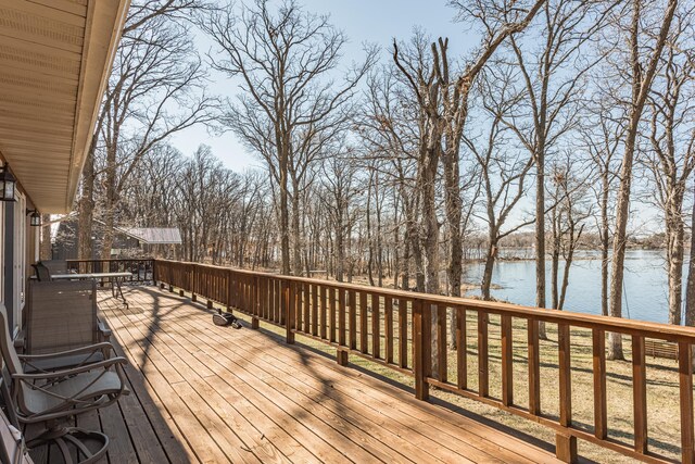 48987 Tamarac Dr, Scambler Twp, MN 56572 - wooden terrace featuring outdoor dining area and a water view