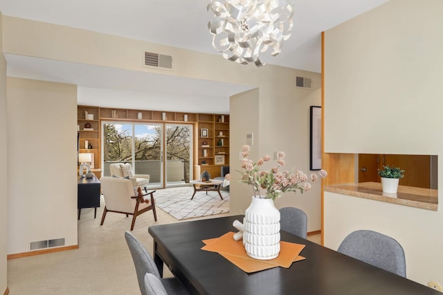 1261 Cleveland Ave N Unit 8A, Saint Paul, MN 55108 - carpeted dining area with built in features, a chandelier, and visible vents