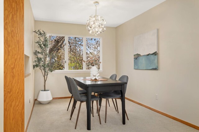 1261 Cleveland Ave N Unit 8A, Saint Paul, MN 55108 - carpeted dining room featuring baseboards and a chandelier