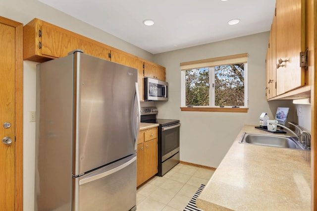 1261 Cleveland Ave N Unit 8A, Saint Paul, MN 55108 - kitchen featuring light tile patterned flooring, baseboards, light countertops, a sink, and appliances with stainless steel finishes