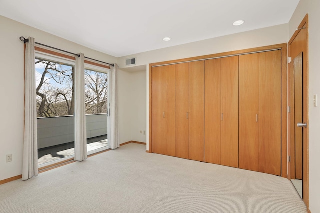 1261 Cleveland Ave N Unit 8A, Saint Paul, MN 55108 - unfurnished bedroom with visible vents, a closet, access to exterior, baseboards, and light colored carpet