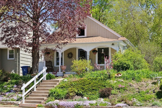 bungalow-style home featuring a porch and a shingled roof