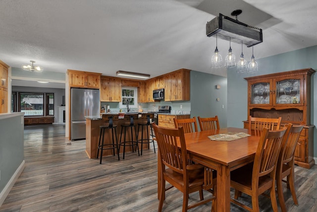 257 Elm Dr, Foley, MN 56329 - dining room featuring a chandelier, dark wood-type flooring, and plenty of natural light