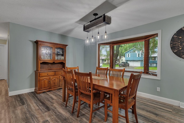 257 Elm Dr, Foley, MN 56329 - dining room featuring dark wood-style flooring and baseboards