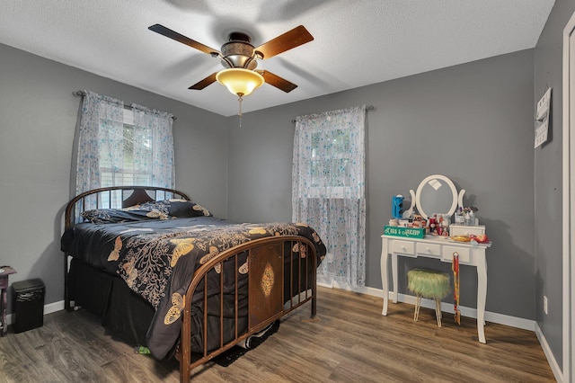 257 Elm Dr, Foley, MN 56329 - bedroom with wood finished floors, a textured ceiling, and a ceiling fan