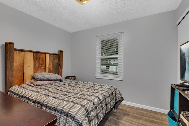 257 Elm Dr, Foley, MN 56329 - bedroom featuring wood finished floors and a textured ceiling