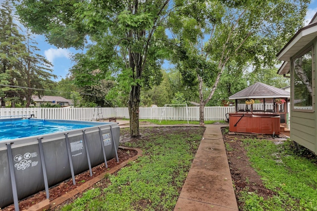 257 Elm Dr, Foley, MN 56329 - fenced backyard featuring a hot tub, a gazebo, and view of scattered trees