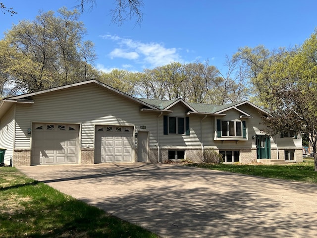 14289 Memorywood Dr, Baxter, MN 56425 - bi-level home with concrete driveway, an attached garage, and brick siding