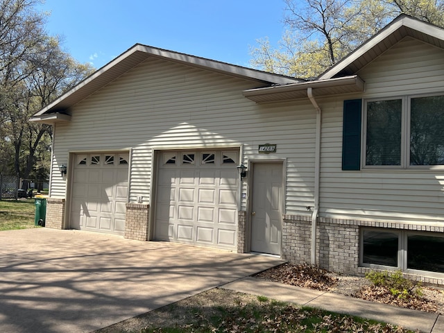 14289 Memorywood Dr, Baxter, MN 56425 - view of front of home featuring brick siding, driveway, and a garage