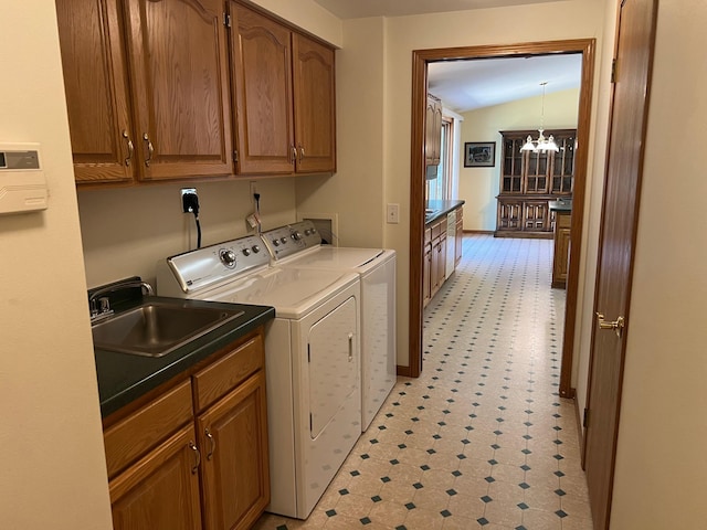 14289 Memorywood Dr, Baxter, MN 56425 - washroom featuring washing machine and clothes dryer, a chandelier, cabinet space, and light flooring