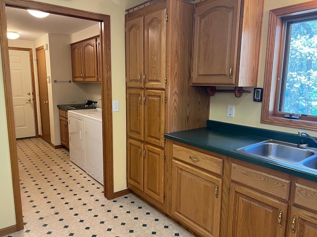 14289 Memorywood Dr, Baxter, MN 56425 - kitchen with separate washer and dryer, a sink, dark countertops, and plenty of natural light
