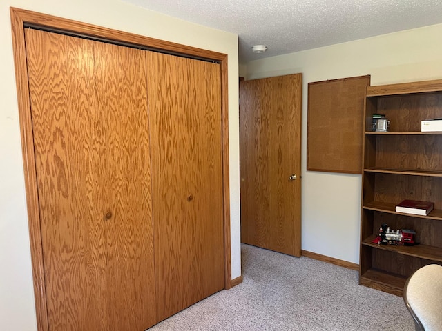 14289 Memorywood Dr, Baxter, MN 56425 - unfurnished bedroom with carpet flooring, a closet, baseboards, and a textured ceiling