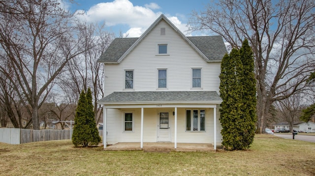 view of front of house featuring covered porch, a front yard, fence, and roof with shingles