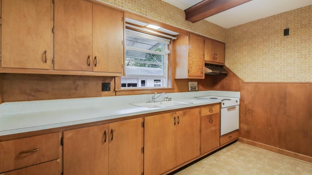 kitchen featuring beam ceiling, a sink, light countertops, white electric range oven, and under cabinet range hood