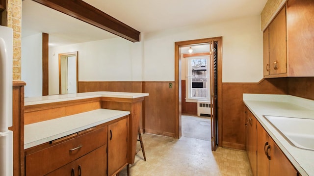 bathroom with wainscoting, vanity, tile patterned floors, beamed ceiling, and radiator