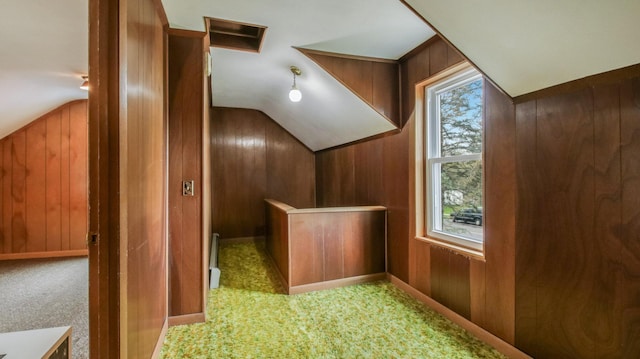additional living space with carpet floors, wooden walls, and lofted ceiling
