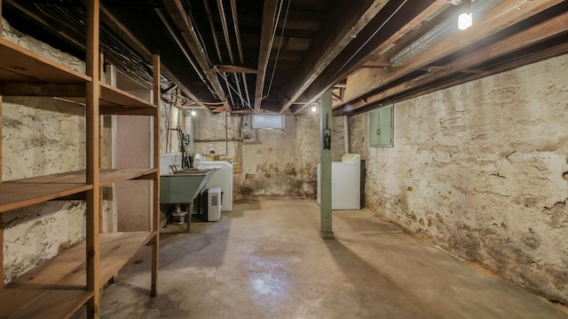 basement with a sink, electric panel, and washer / clothes dryer