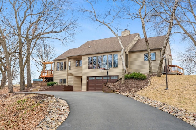 8440 Delaney Ct, Inver Grove Heights, MN 55076 - view of front of property featuring driveway, a chimney, a garage, roof with shingles, and a deck