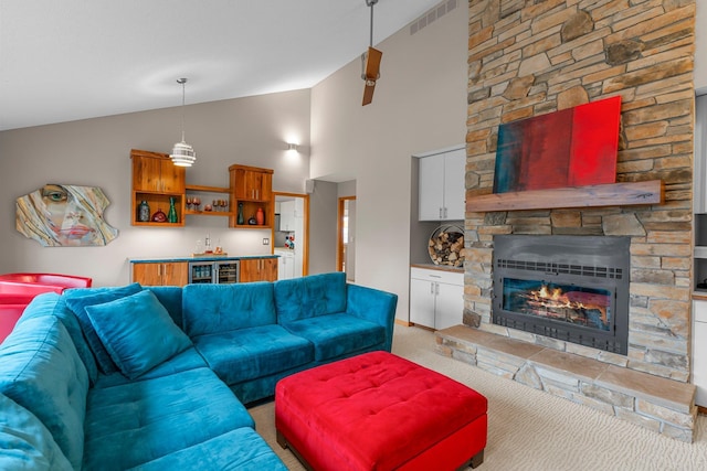 8440 Delaney Ct, Inver Grove Heights, MN 55076 - living area with vaulted ceiling, light carpet, a fireplace, and beverage cooler