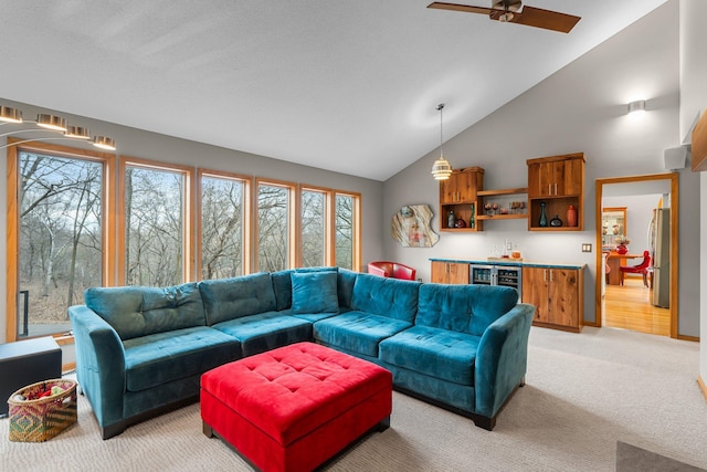 8440 Delaney Ct, Inver Grove Heights, MN 55076 - living area with a bar, light carpet, ceiling fan, beverage cooler, and high vaulted ceiling