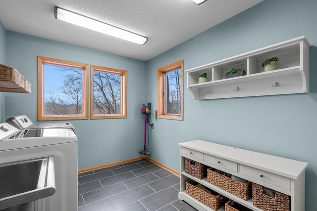 8440 Delaney Ct, Inver Grove Heights, MN 55076 - laundry room with independent washer and dryer, baseboards, a textured ceiling, and dark tile patterned floors