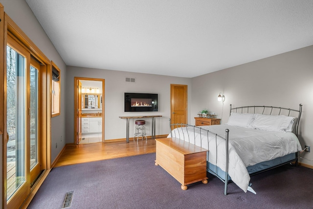 8440 Delaney Ct, Inver Grove Heights, MN 55076 - bedroom with carpet flooring, baseboards, and ensuite bath