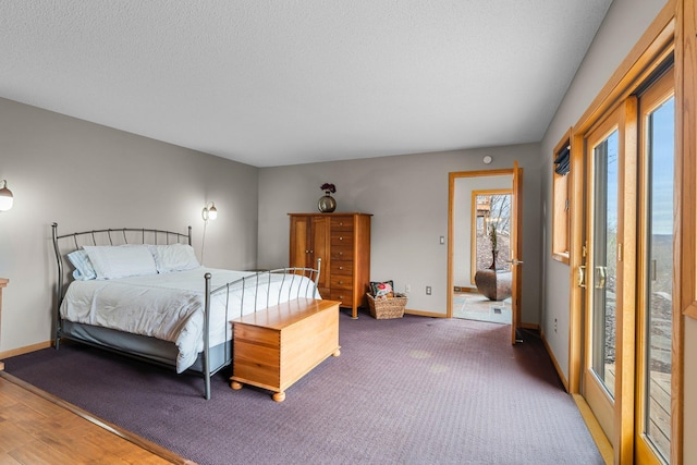 8440 Delaney Ct, Inver Grove Heights, MN 55076 - bedroom featuring multiple windows, baseboards, a textured ceiling, and wood finished floors