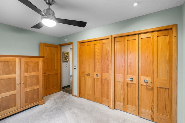 8440 Delaney Ct, Inver Grove Heights, MN 55076 - unfurnished bedroom with carpet, two closets, and a ceiling fan