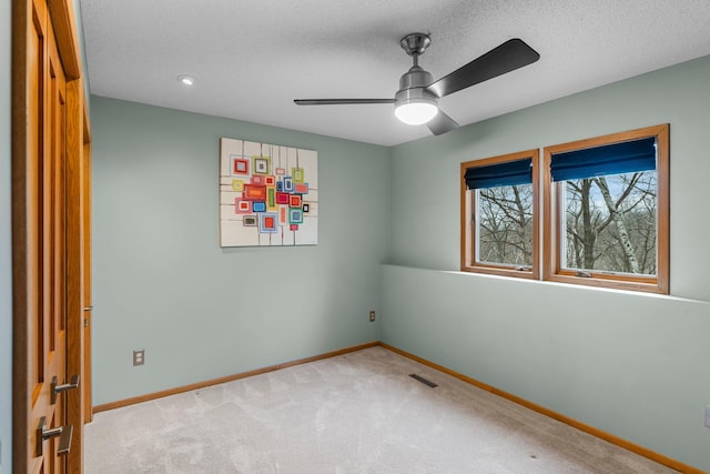 8440 Delaney Ct, Inver Grove Heights, MN 55076 - spare room featuring baseboards, carpet flooring, a ceiling fan, and a textured ceiling