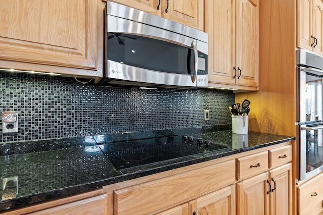707 Bergman Ct NW, Isanti, MN 55040 - kitchen featuring dark stone counters, decorative backsplash, light brown cabinets, and stainless steel appliances