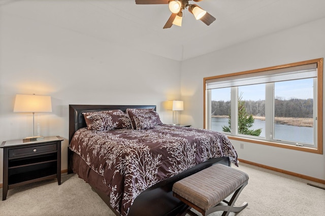 707 Bergman Ct NW, Isanti, MN 55040 - carpeted bedroom with a water view, visible vents, baseboards, and a ceiling fan