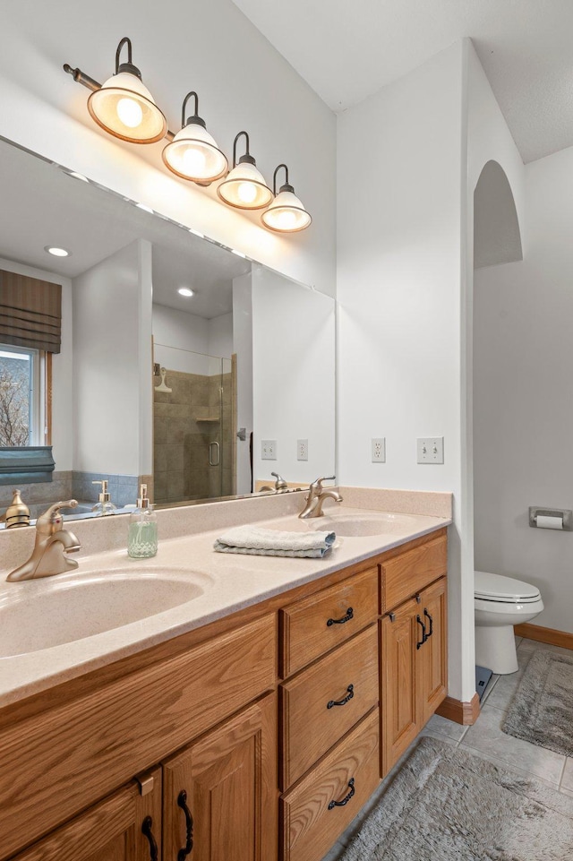 707 Bergman Ct NW, Isanti, MN 55040 - full bathroom featuring a shower stall, double vanity, a sink, and toilet