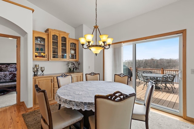 707 Bergman Ct NW, Isanti, MN 55040 - dining area featuring light wood-style flooring, an inviting chandelier, and vaulted ceiling