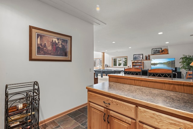 707 Bergman Ct NW, Isanti, MN 55040 - kitchen with stone finish floor, dark countertops, baseboards, and recessed lighting