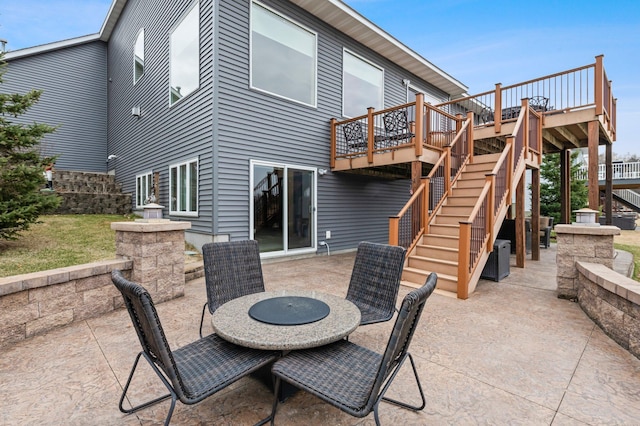 707 Bergman Ct NW, Isanti, MN 55040 - back of property with a patio, a deck, and stairs