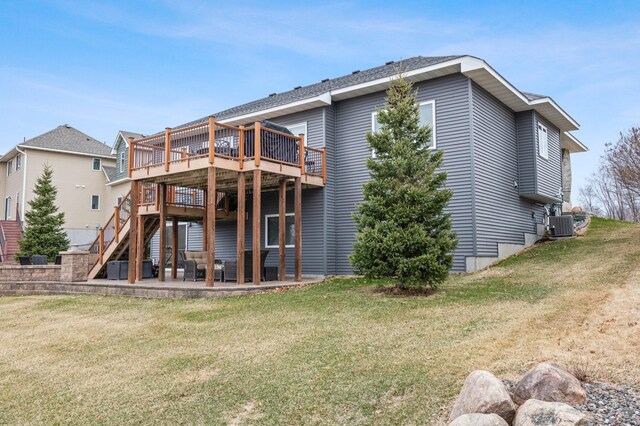 707 Bergman Ct NW, Isanti, MN 55040 - back of house with central AC, a lawn, stairway, a patio, and a wooden deck
