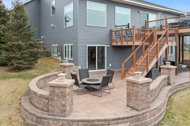 707 Bergman Ct NW, Isanti, MN 55040 - rear view of property featuring a patio area, a wooden deck, and stairs