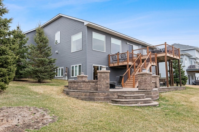 707 Bergman Ct NW, Isanti, MN 55040 - rear view of property featuring a yard, a patio area, a deck, and stairs