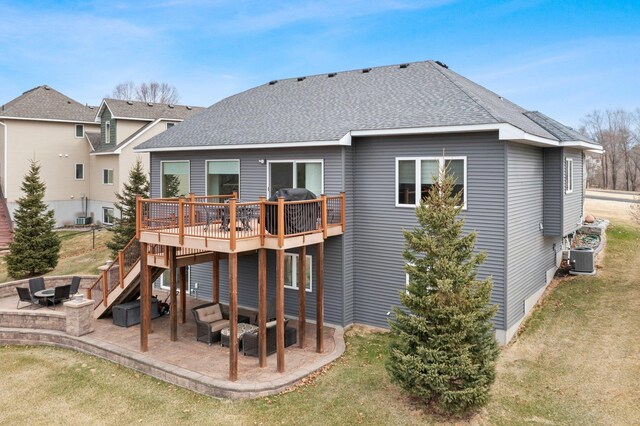 707 Bergman Ct NW, Isanti, MN 55040 - rear view of house featuring an outdoor fire pit, a patio, a wooden deck, and roof with shingles