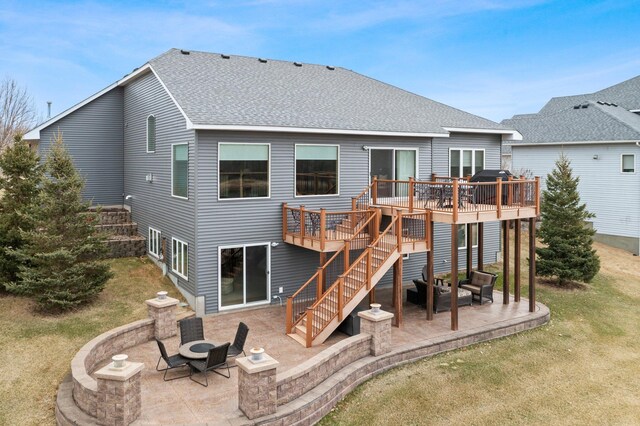 707 Bergman Ct NW, Isanti, MN 55040 - rear view of house featuring a patio area, stairway, a wooden deck, and a shingled roof